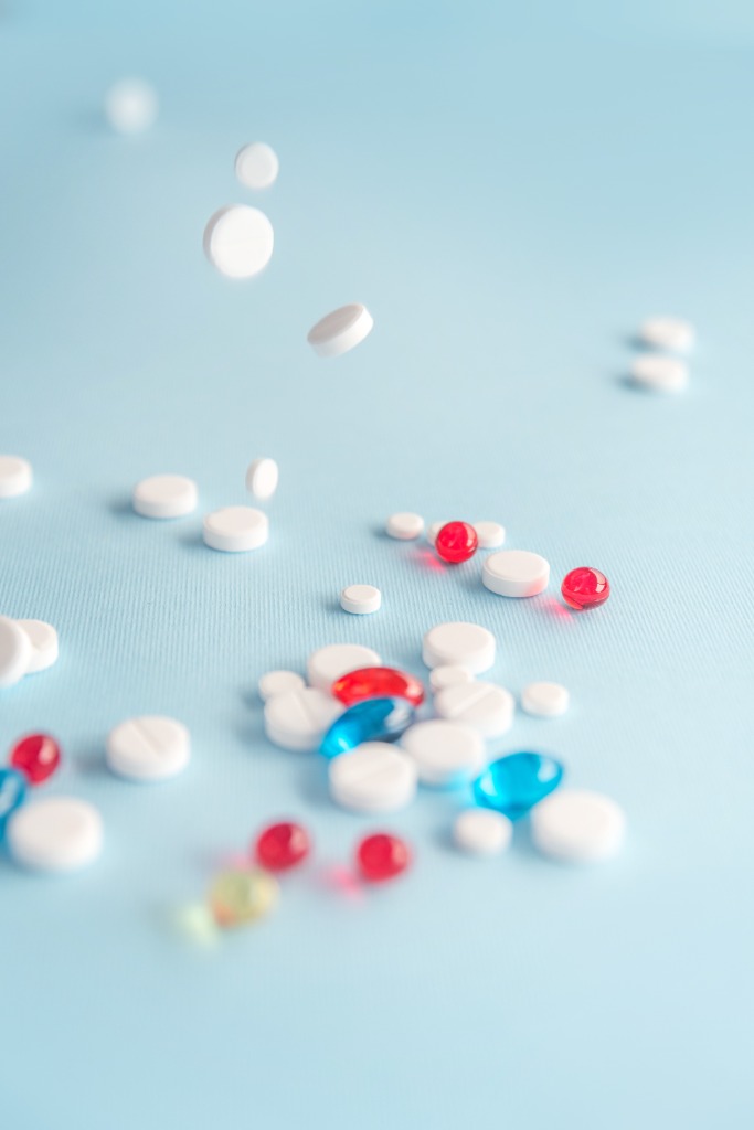 Assorted pharmacy medications on a light blue background